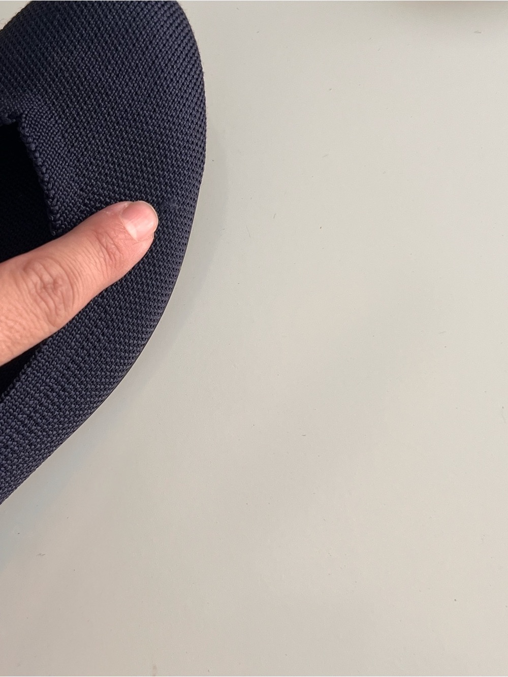 Rothy's navy blue round-toe knit flat shoes featuring a distinctive bright blue - Picture 10 of 12